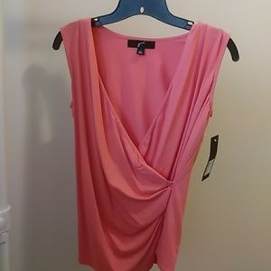 Coral wrap v-neck sleeveless blouse.